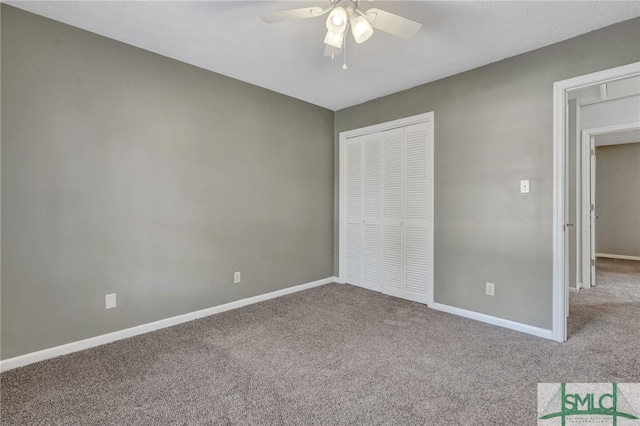 unfurnished bedroom featuring a closet, ceiling fan, and carpet