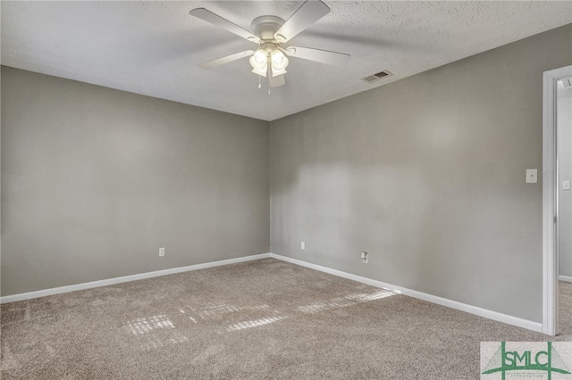 spare room with carpet, a textured ceiling, and ceiling fan