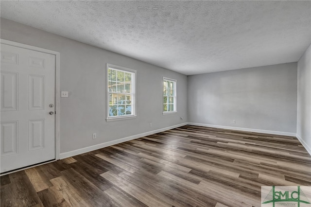 entrance foyer featuring dark hardwood / wood-style floors and a textured ceiling