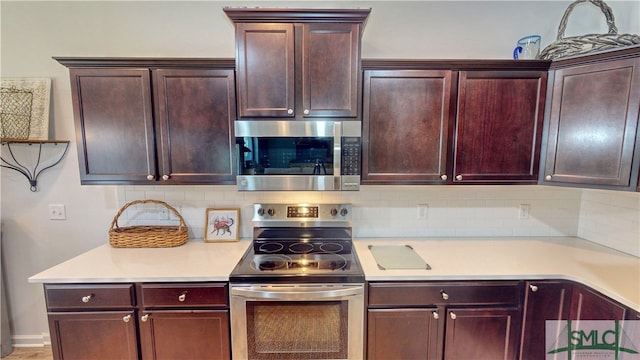 kitchen featuring appliances with stainless steel finishes and tasteful backsplash