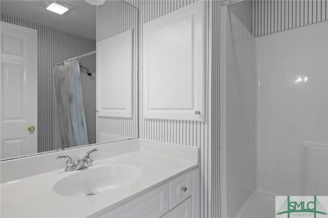 bathroom featuring vanity and curtained shower