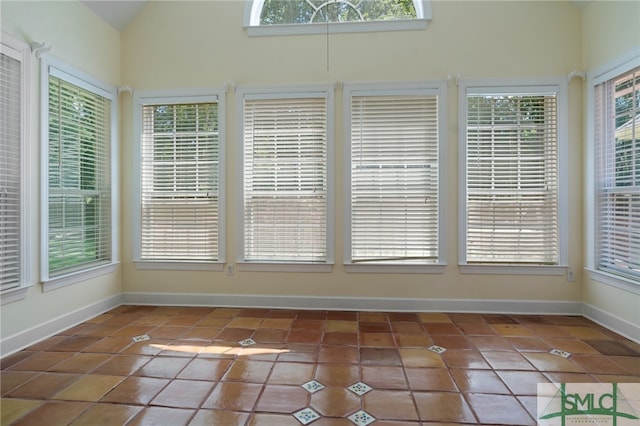 unfurnished sunroom featuring lofted ceiling