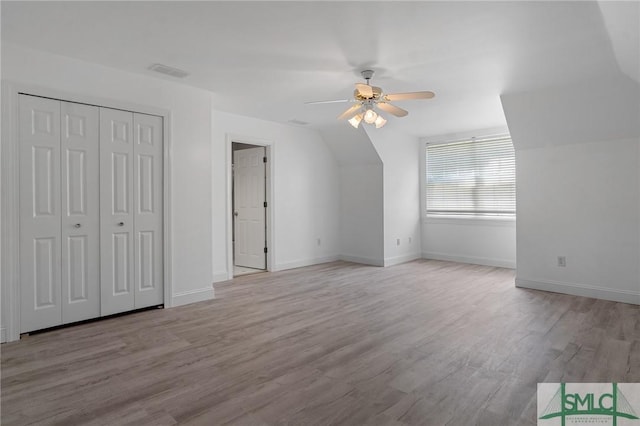 bonus room with visible vents, baseboards, lofted ceiling, a ceiling fan, and wood finished floors