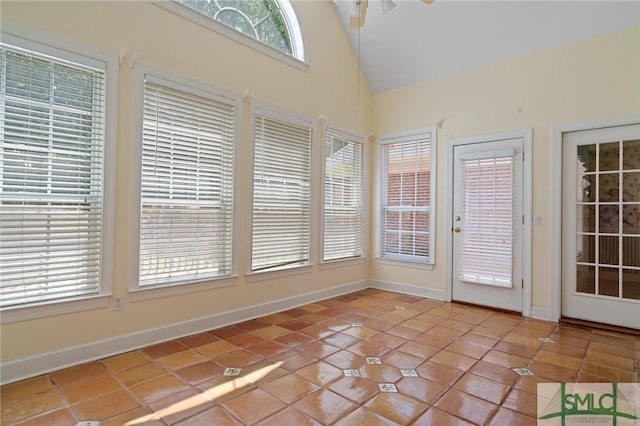 unfurnished sunroom with ceiling fan and lofted ceiling