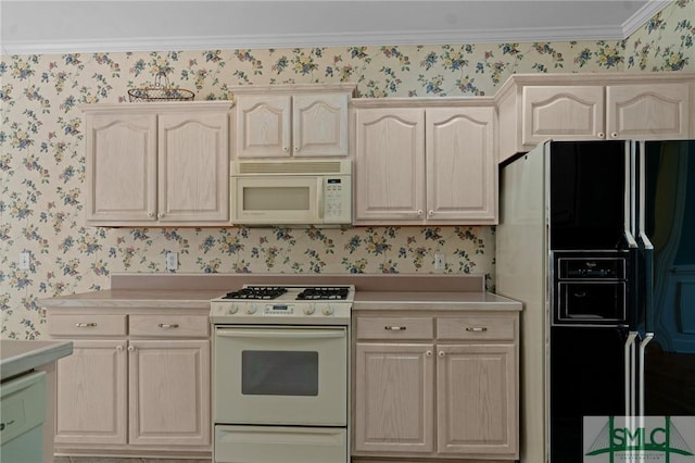 kitchen with light brown cabinets, wallpapered walls, white appliances, and light countertops
