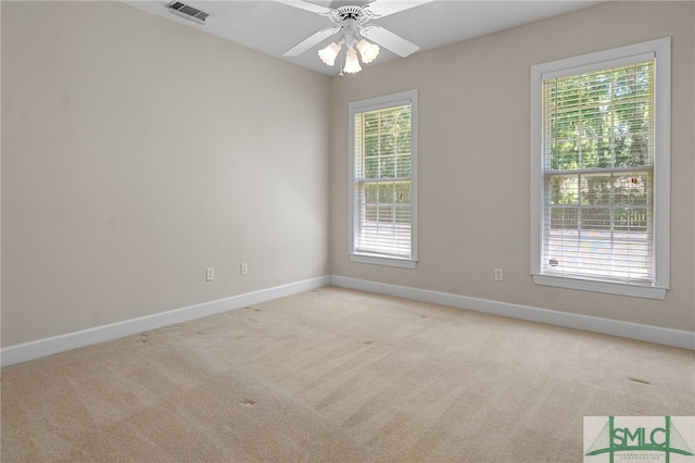 empty room featuring light colored carpet and ceiling fan