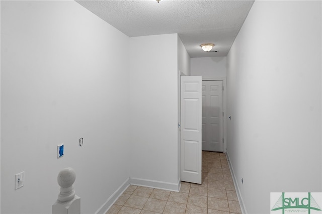 interior space featuring a textured ceiling and light tile patterned floors