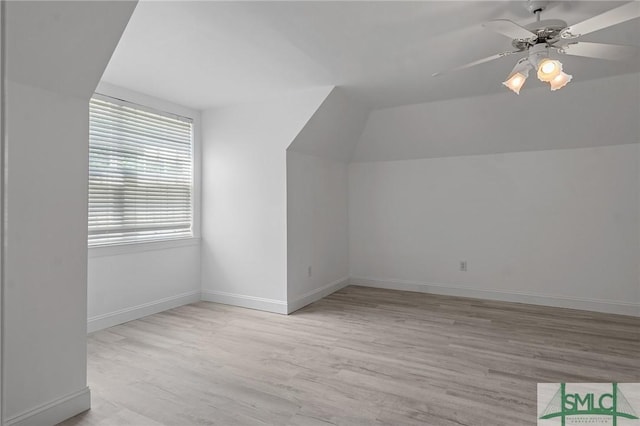bonus room with ceiling fan, lofted ceiling, light wood-style floors, and baseboards