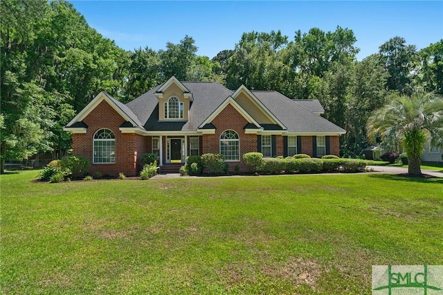 view of front of house with brick siding and a front lawn