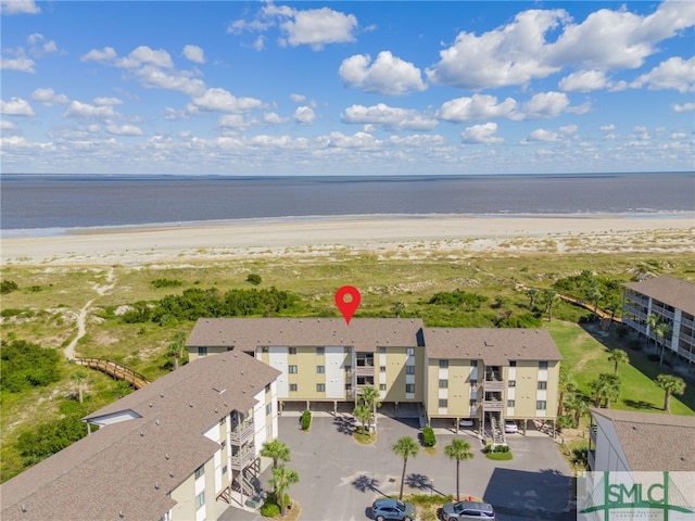 bird's eye view with a water view and a view of the beach