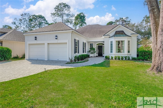 view of front of home with a front lawn and a garage