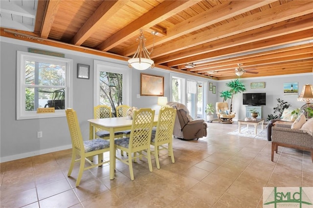 dining space with beamed ceiling, a wealth of natural light, and light tile patterned floors