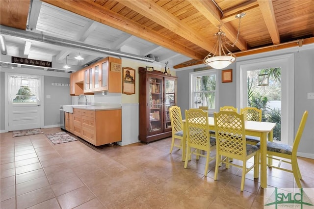 dining area featuring wood ceiling, baseboards, beamed ceiling, and light tile patterned flooring