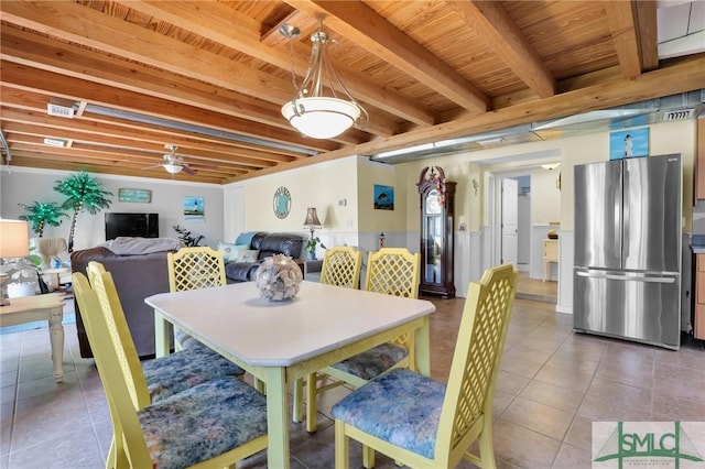 tiled dining area featuring wooden ceiling, beam ceiling, and ceiling fan