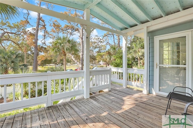 unfurnished sunroom featuring beam ceiling