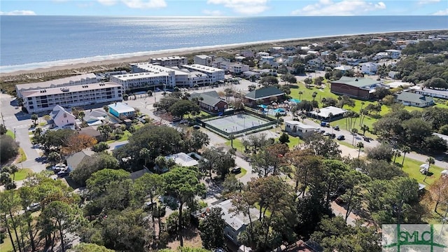 birds eye view of property with a beach view and a water view