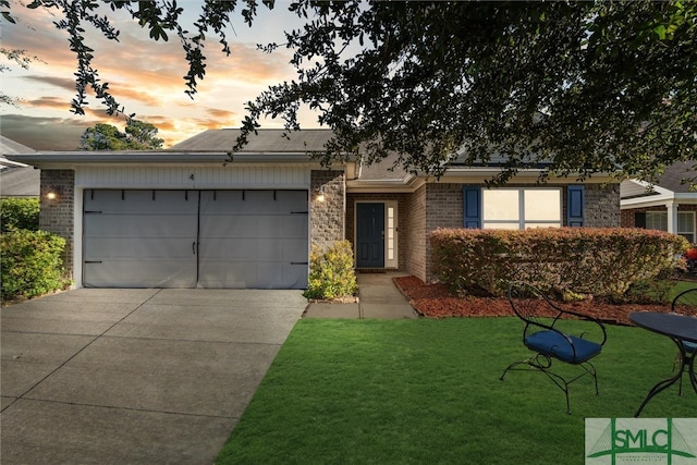 ranch-style house with a lawn and a garage