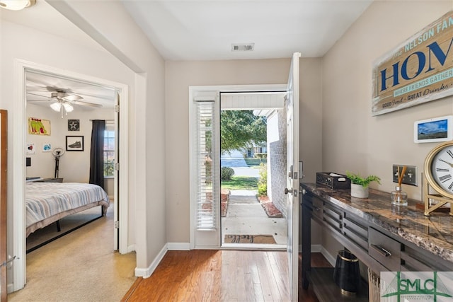 foyer featuring light hardwood / wood-style flooring, a healthy amount of sunlight, and ceiling fan