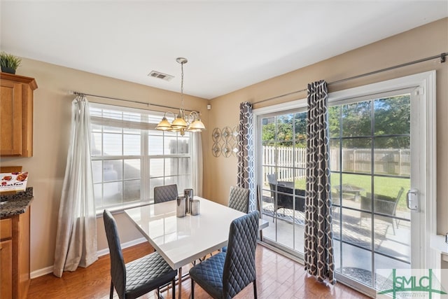 dining area with a chandelier and hardwood / wood-style flooring