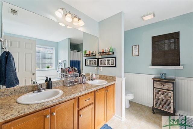 bathroom featuring toilet and vanity