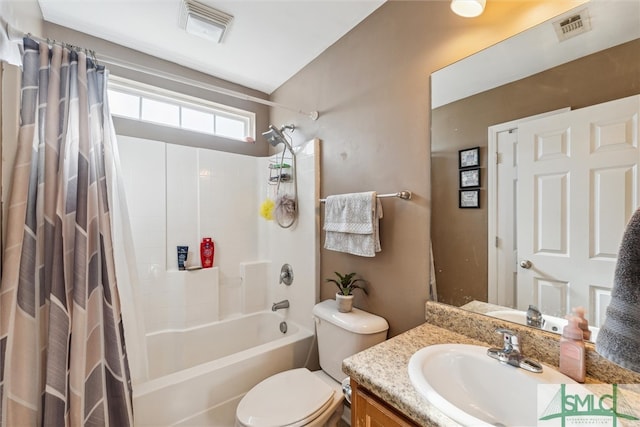 full bathroom featuring vanity, shower / bath combo with shower curtain, and toilet