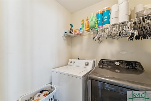 clothes washing area with washing machine and clothes dryer