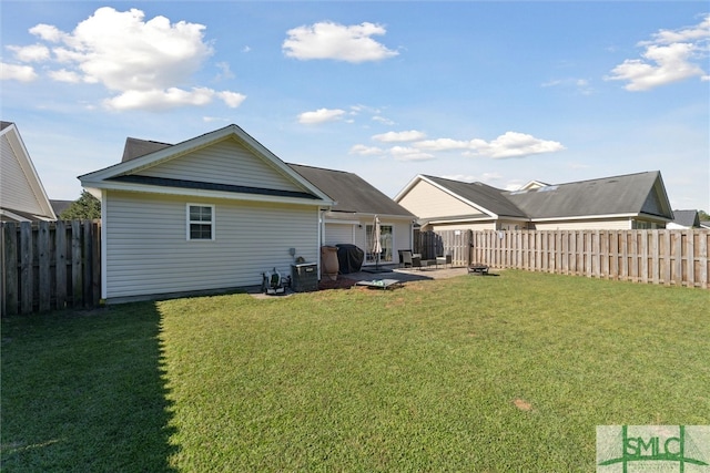 back of house featuring a patio and a yard