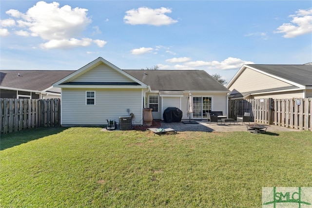 back of house featuring a patio, a fire pit, and a yard