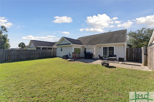 rear view of property with a yard and a patio area