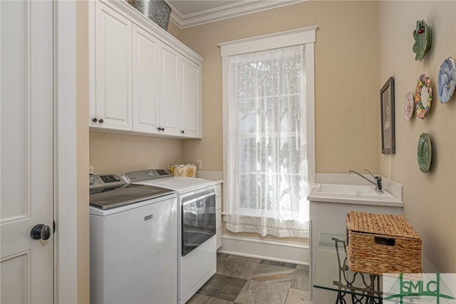 laundry room featuring sink, ornamental molding, cabinets, and washer and clothes dryer