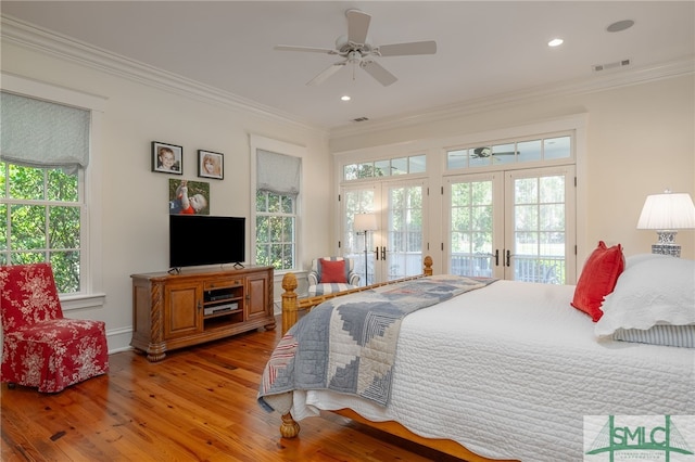 bedroom featuring access to outside, french doors, multiple windows, and wood-type flooring