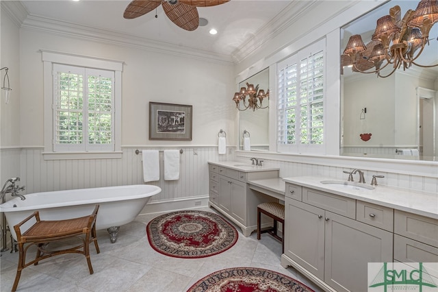 bathroom with ceiling fan, ornamental molding, vanity, a tub to relax in, and tile patterned floors