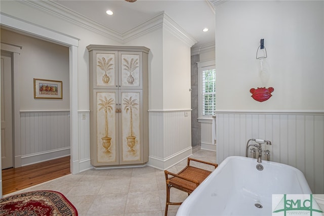 bathroom featuring ornamental molding, a bathtub, and tile patterned floors