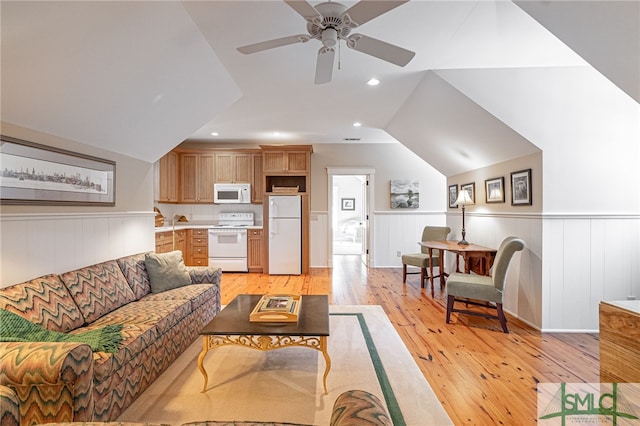 living room with light hardwood / wood-style flooring, lofted ceiling, and ceiling fan