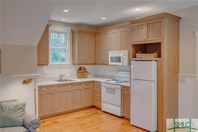 kitchen with white appliances, light hardwood / wood-style flooring, light brown cabinetry, and sink