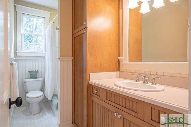 bathroom with vanity, a shower with shower curtain, toilet, and tile patterned flooring