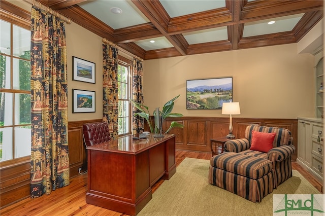 office space featuring light hardwood / wood-style floors, coffered ceiling, beamed ceiling, and crown molding