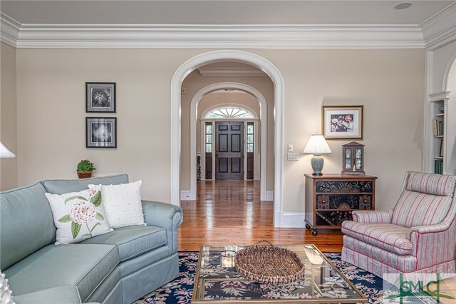 living room with crown molding and hardwood / wood-style flooring