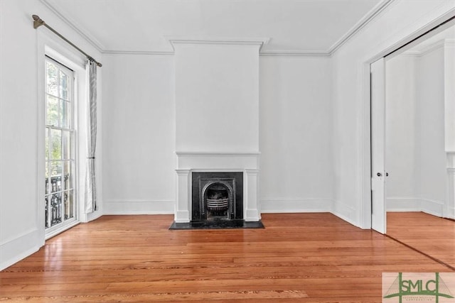 117 W Gaston St, Savannah, GA 31401 - unfurnished living room featuring crown molding, wood finished floors, and a fireplace