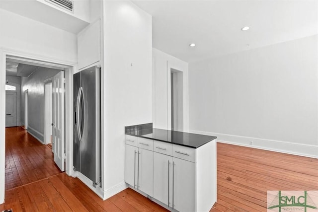 117 W Gaston St, Savannah, GA 31401 - kitchen featuring stainless steel fridge, dark countertops, a peninsula, and light wood finished floors