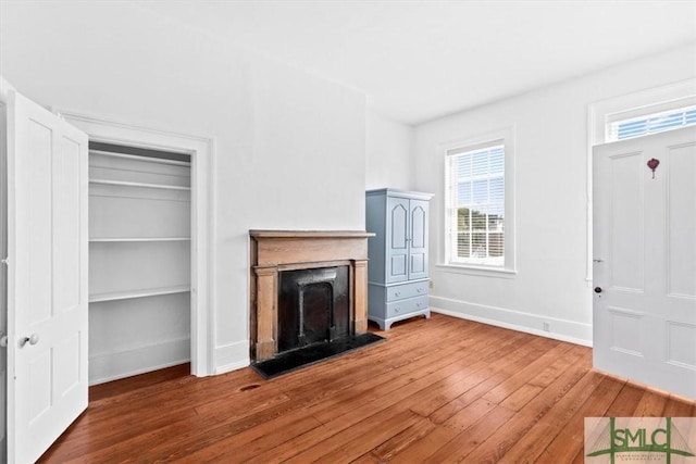 117 W Gaston St, Savannah, GA 31401 - unfurnished living room with baseboards, plenty of natural light, and hardwood / wood-style flooring