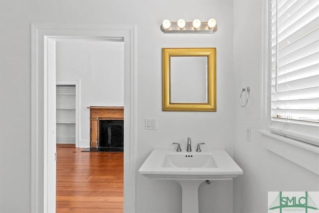 117 W Gaston St, Savannah, GA 31401 - bathroom featuring a fireplace with flush hearth and wood finished floors