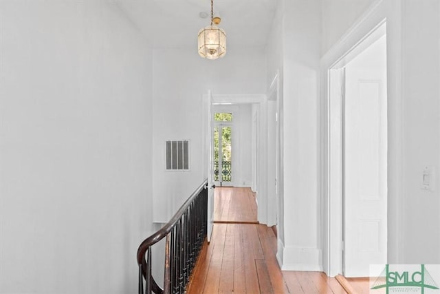117 W Gaston St, Savannah, GA 31401 - hallway featuring visible vents, hardwood / wood-style floors, and an upstairs landing
