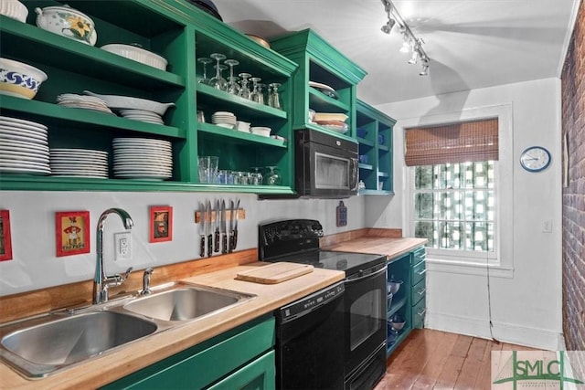 117 W Gaston St, Savannah, GA 31401 - kitchen with open shelves, wood finished floors, green cabinetry, a sink, and black appliances
