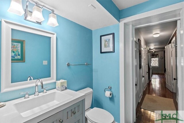 117 W Gaston St, Savannah, GA 31401 - bathroom with vanity, toilet, and hardwood / wood-style floors