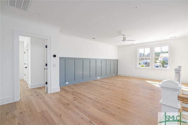 unfurnished room featuring crown molding, ceiling fan, and light hardwood / wood-style floors