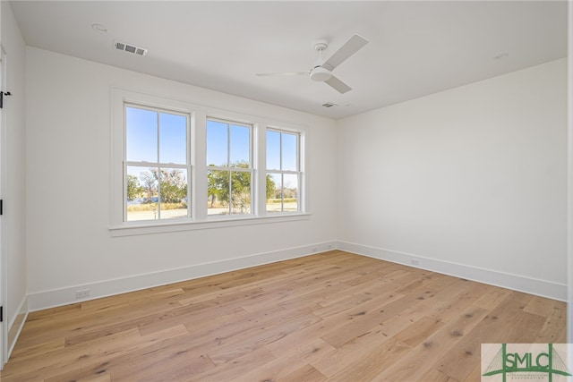 empty room featuring ceiling fan and light hardwood / wood-style flooring