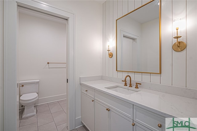 bathroom featuring tile patterned floors, toilet, and vanity