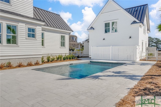 view of pool featuring a patio area, fence, and a fenced in pool