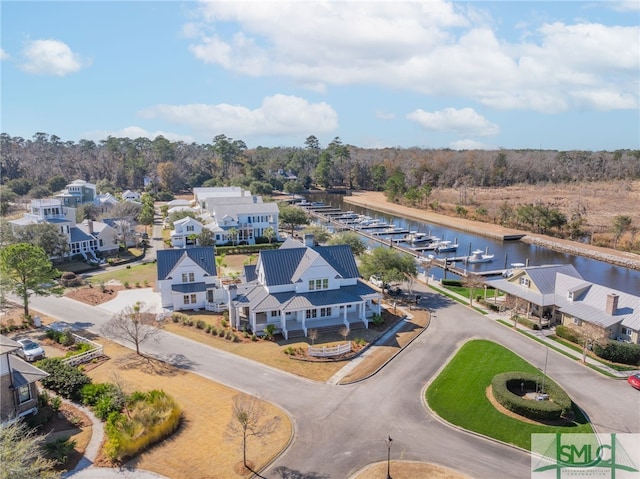 bird's eye view with a water view and a residential view